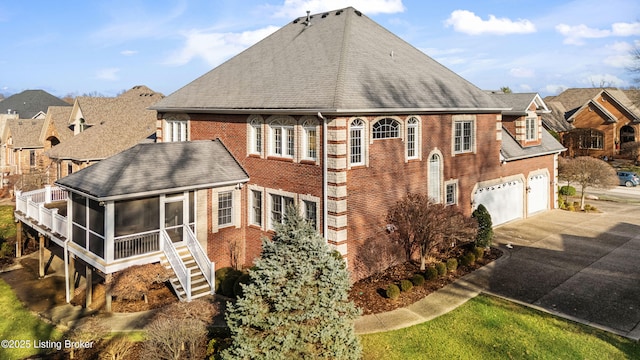 view of home's exterior featuring a sunroom and a garage