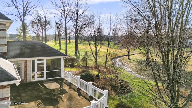 wooden deck with a patio area and a sunroom