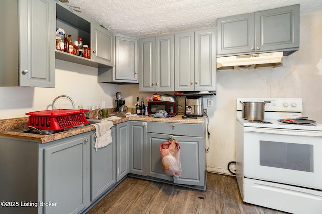 kitchen with gray cabinetry, dark wood-type flooring, white electric range, and a textured ceiling