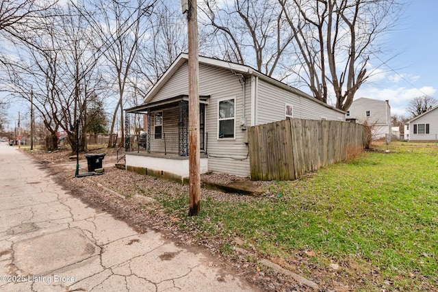 view of side of home with a lawn