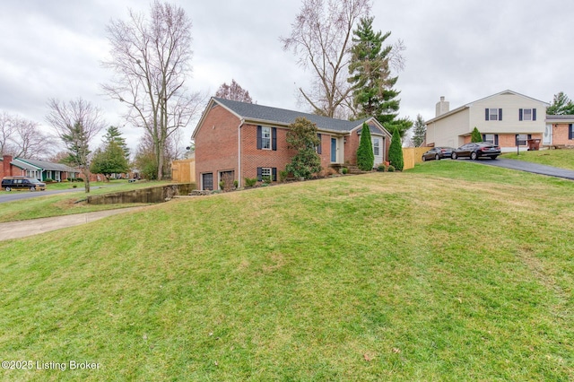 view of front of house featuring a garage and a front lawn