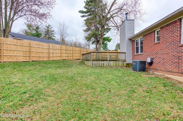 view of yard with central air condition unit and a deck