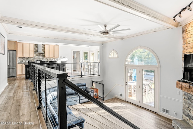 interior space with hardwood / wood-style floors, ceiling fan, and crown molding