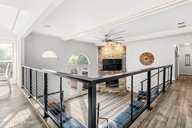 hall with hardwood / wood-style flooring and ornamental molding