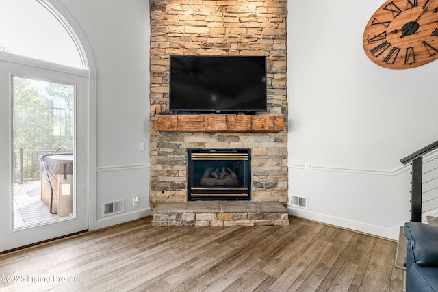 unfurnished living room featuring wood-type flooring and a fireplace