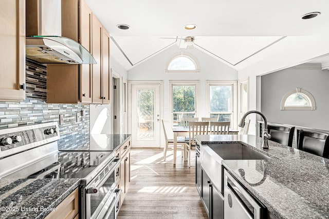 kitchen with electric range, tasteful backsplash, dark stone counters, extractor fan, and lofted ceiling