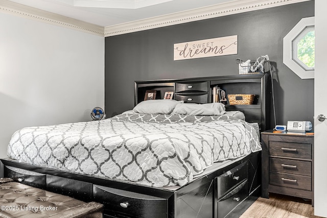 bedroom featuring light hardwood / wood-style floors and ornamental molding