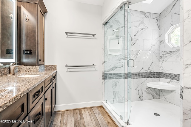 bathroom featuring vanity and a shower with shower door