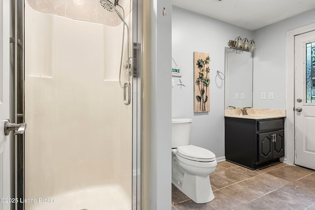 bathroom featuring toilet, vanity, and walk in shower