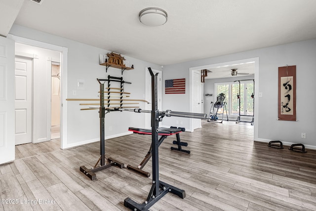 workout room featuring hardwood / wood-style flooring and ceiling fan