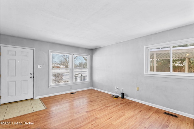 entryway with a healthy amount of sunlight and light hardwood / wood-style floors