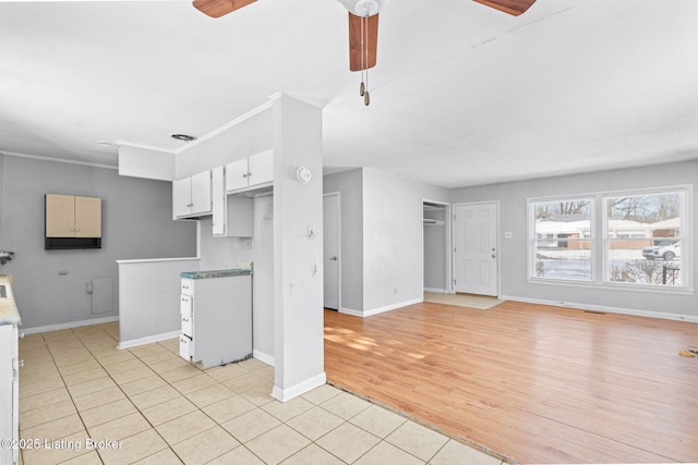 kitchen featuring white cabinets, light tile patterned flooring, and ceiling fan