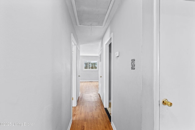 corridor with light hardwood / wood-style flooring