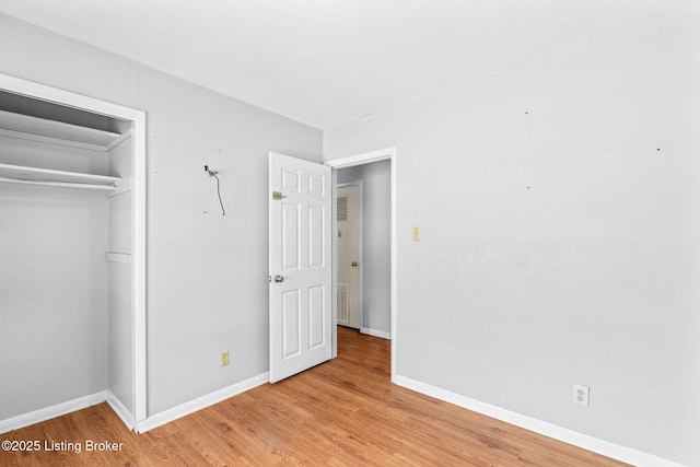 unfurnished bedroom featuring a closet and light hardwood / wood-style flooring