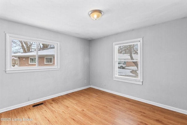 spare room featuring light hardwood / wood-style floors