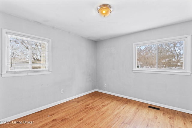 spare room with hardwood / wood-style flooring