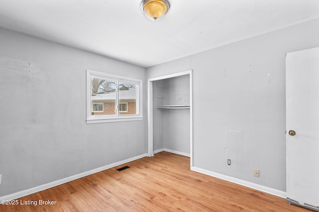 unfurnished bedroom with light hardwood / wood-style floors and a closet