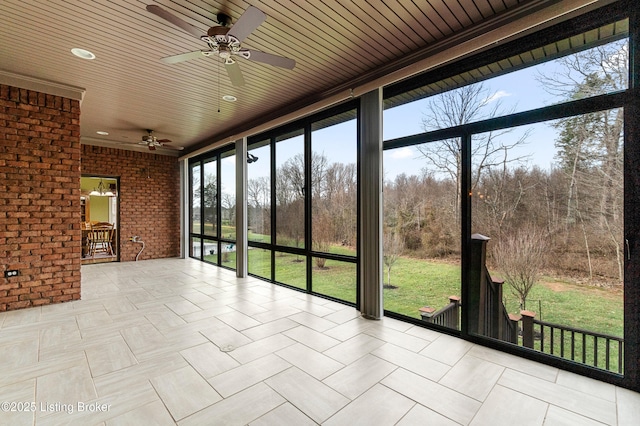 unfurnished sunroom featuring ceiling fan and wooden ceiling