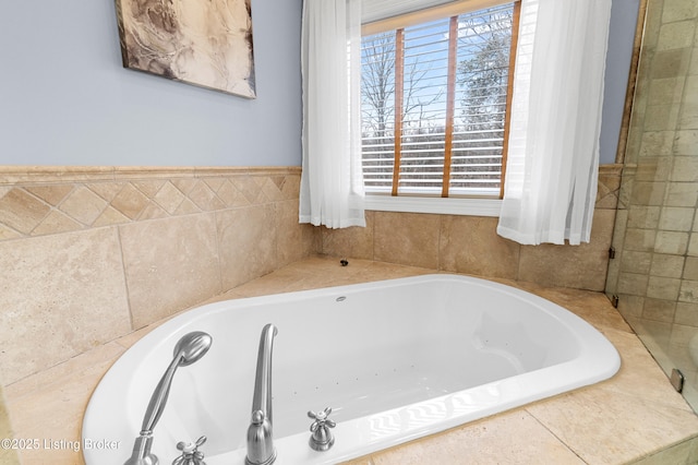 bathroom with a wealth of natural light and tiled tub