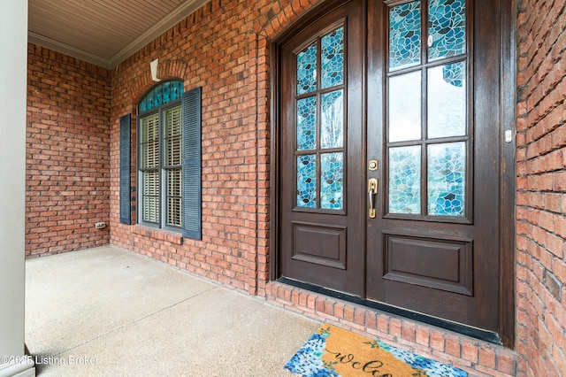 view of exterior entry featuring covered porch