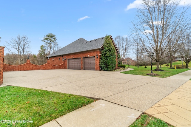 view of side of home with a yard and a garage