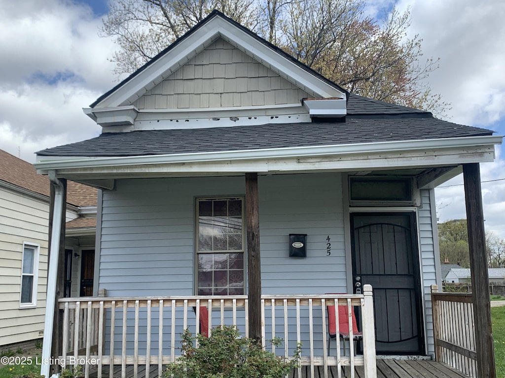view of front of home featuring covered porch and roof with shingles