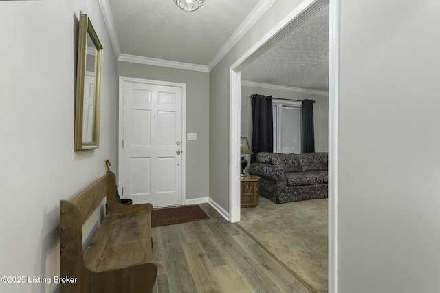 foyer with hardwood / wood-style floors, a textured ceiling, and ornamental molding