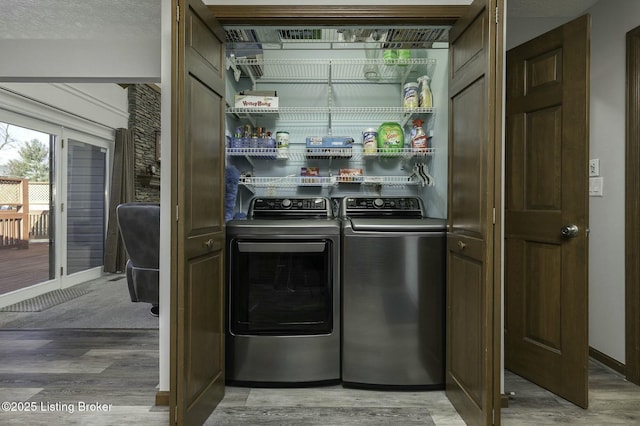 washroom featuring washer and dryer, a textured ceiling, and hardwood / wood-style flooring