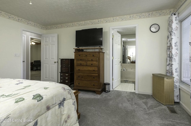 bedroom featuring a textured ceiling, light colored carpet, and connected bathroom