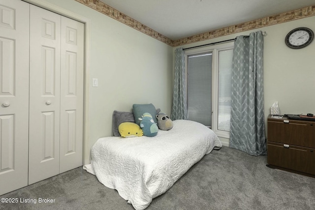 bedroom featuring light colored carpet and a closet