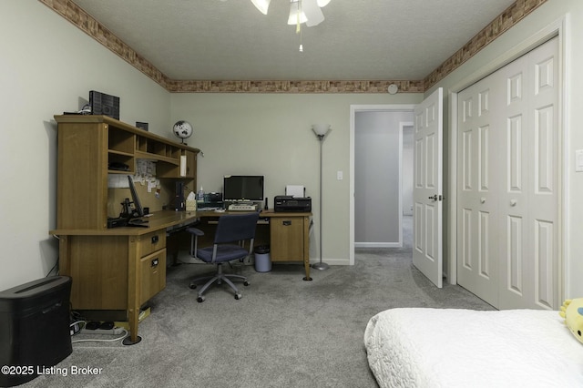 carpeted bedroom featuring a textured ceiling and ceiling fan