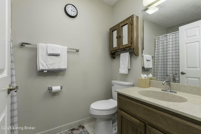 bathroom featuring tile patterned floors, vanity, and toilet