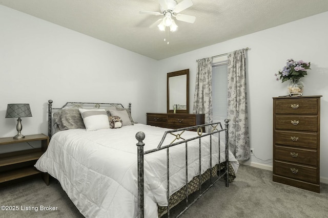 bedroom featuring carpet flooring, ceiling fan, and a textured ceiling