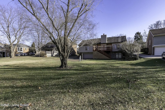 view of yard featuring a garage and a deck