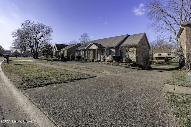 ranch-style home with a front lawn