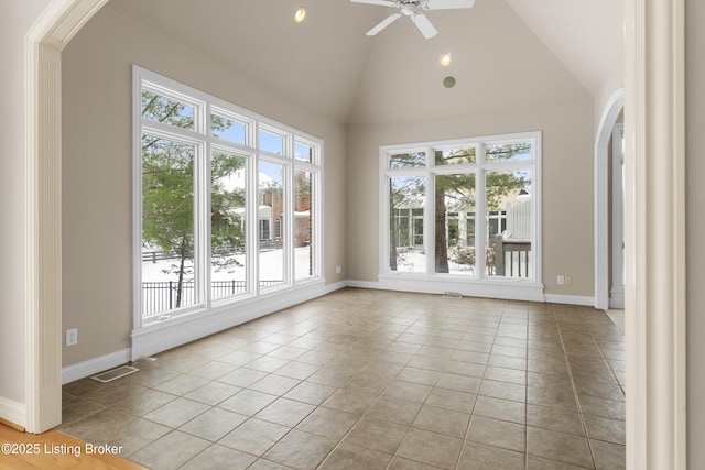 tiled spare room with high vaulted ceiling and ceiling fan