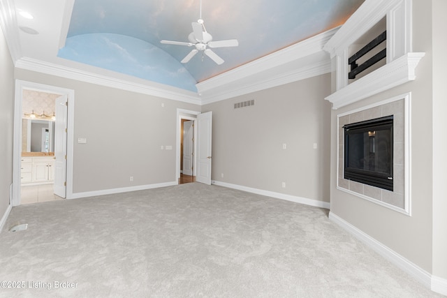 unfurnished living room with a tile fireplace, ceiling fan, crown molding, and vaulted ceiling