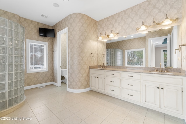 bathroom with tile patterned flooring, vanity, and toilet