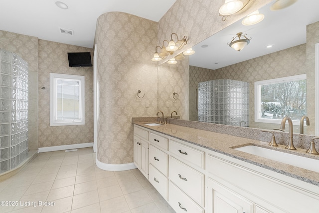 bathroom with tile patterned flooring, plenty of natural light, and vanity