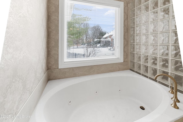 bathroom featuring a bathing tub and a healthy amount of sunlight