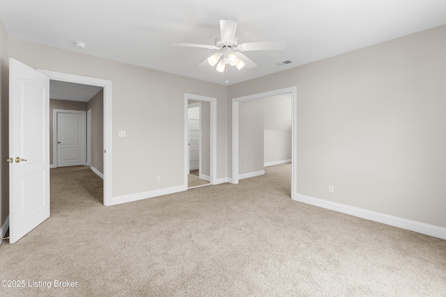 unfurnished bedroom with connected bathroom, ceiling fan, and light carpet