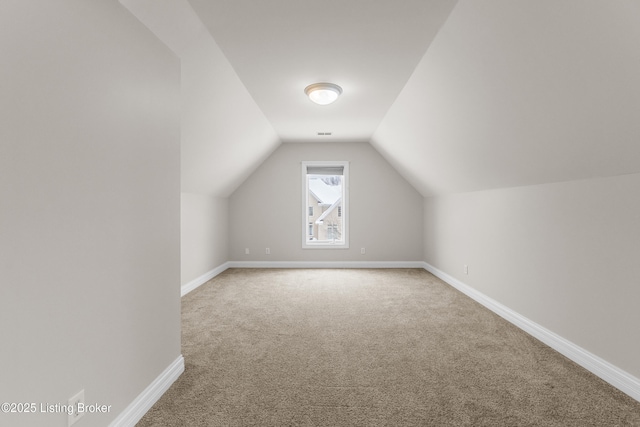 bonus room with carpet and lofted ceiling