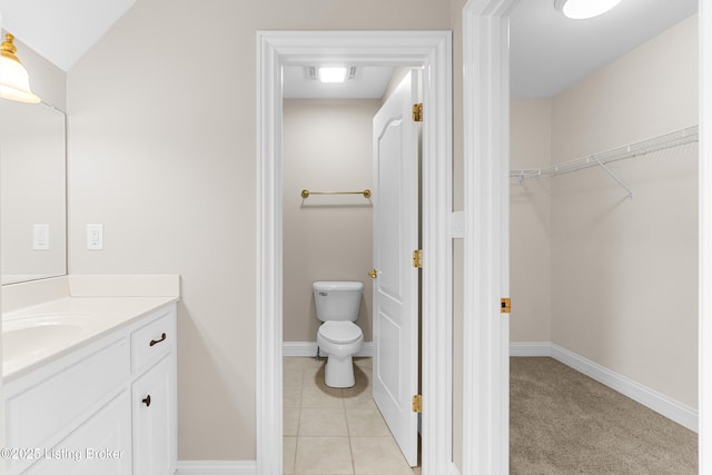 bathroom with tile patterned flooring, vanity, and toilet