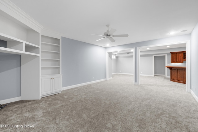 interior space featuring ceiling fan, built in features, and light carpet