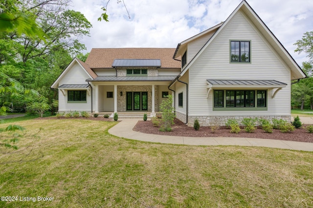 modern inspired farmhouse featuring a porch and a front yard