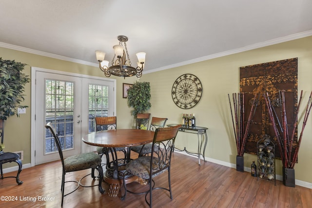 dining space featuring a chandelier, crown molding, and french doors