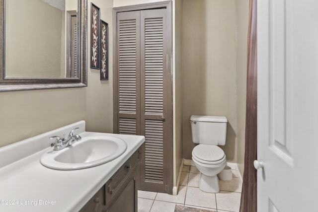 bathroom with tile patterned flooring, vanity, and toilet