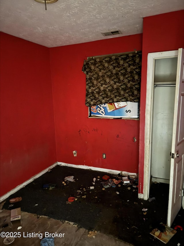 unfurnished bedroom featuring a textured ceiling