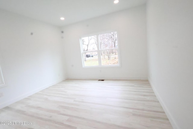 empty room with light hardwood / wood-style floors