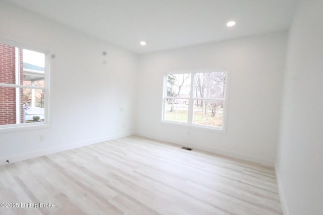 spare room featuring light hardwood / wood-style flooring